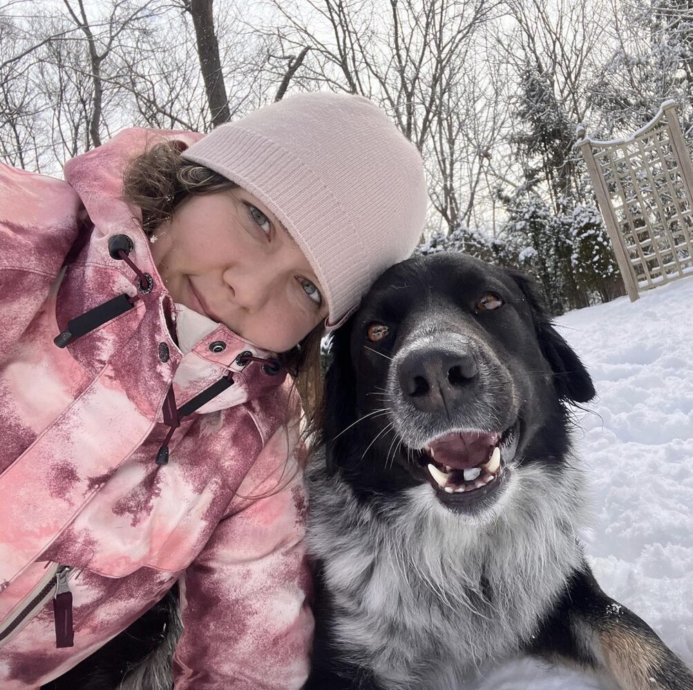 Kristina with a dog in the snow